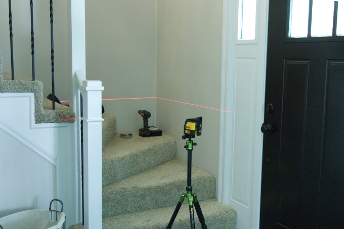 Dewalt Laser Level projecting laser beam across stairwell