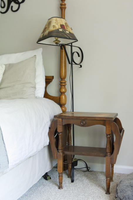 Old Magazine Rack as Bedside Table Nightstand and Old Farm Lamp in Master Bedroom