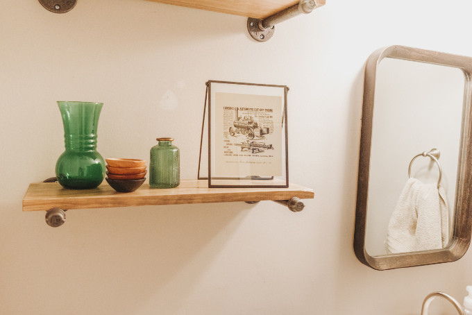 Half bathroom makeover shelving vintage industrial farmhouse decor plants modern vintage print on industrial shelf