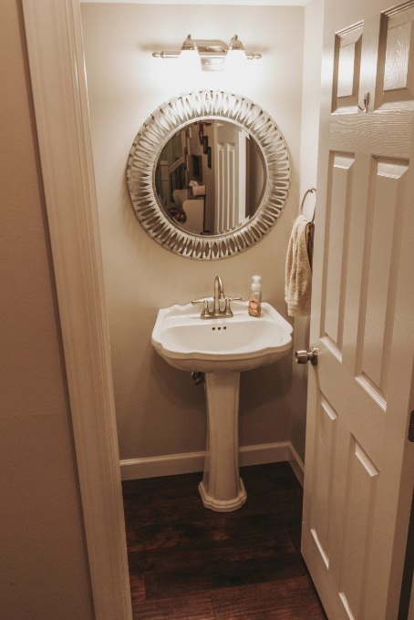Half bathroom makeover shelving vintage industrial farmhouse decor plants modern glam metal mirror before