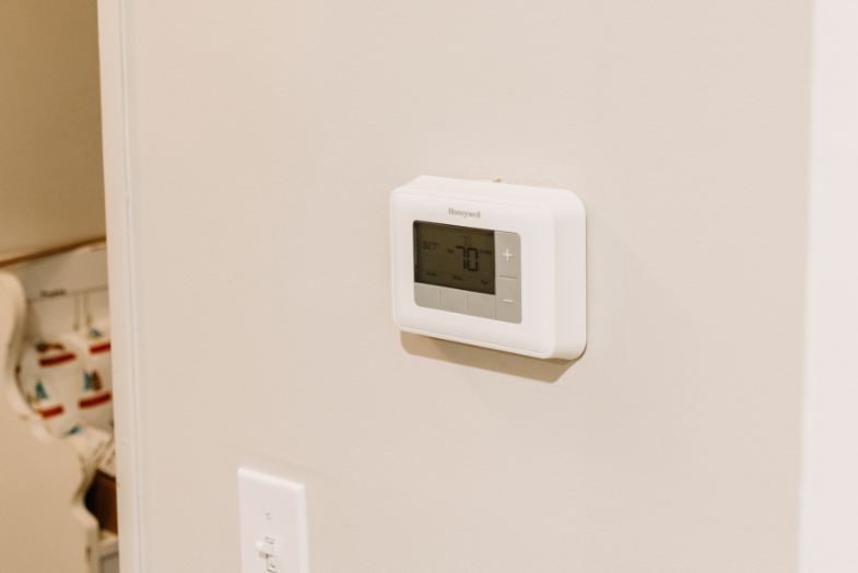 Old Honeywell themostat installed on wall in entryway